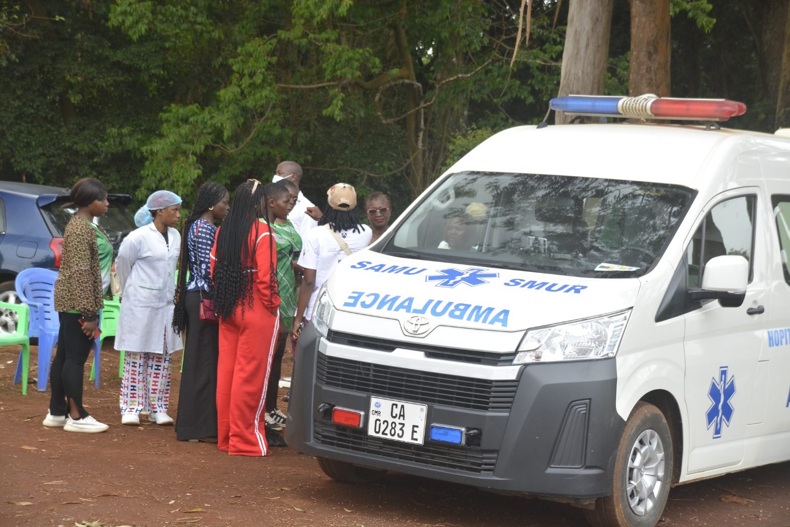 Une ambulance du SAMU et une équipe de santé stationnées au bord du terrain.