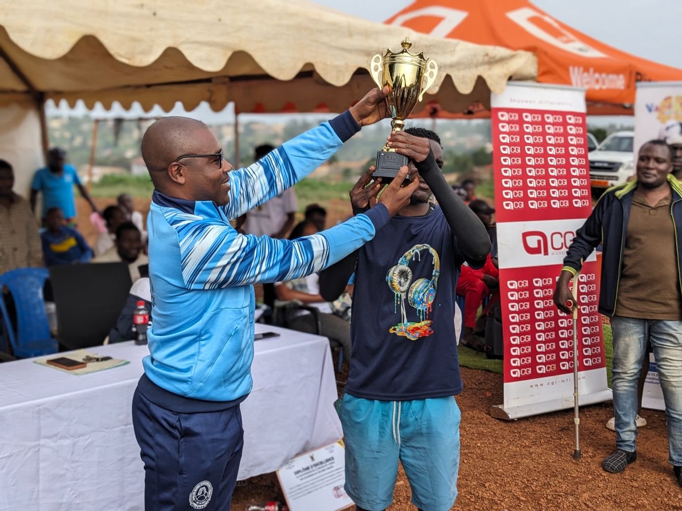 Sous la tente officielle, le Délégué Départemental de la Mifi remet le trophée du football masculin.